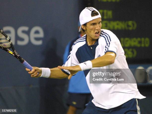 26th seed Juan Ignacio Chela scores a straight-set victory over fifth seed Tim Henman, 6-3, 6-3, 6-2.