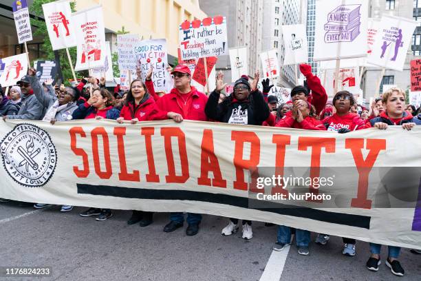 Striking Chicago public school teachers and other unionized staff and their supporters march through the Loop on day two of their strike on October...