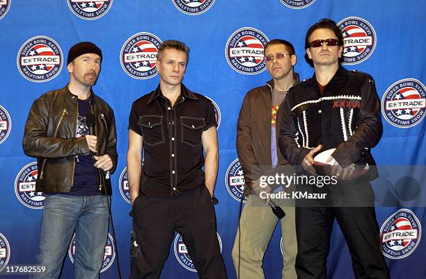 Pose for photographers January 30, 2002 at a press conference at the Superdome in New Orleans, Louisiana, days before their live performance during...