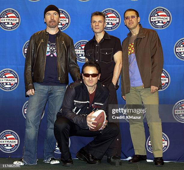 Pose for photographers January 30, 2002 at a press conference at the Superdome in New Orleans, Louisiana, days before their live performance during...