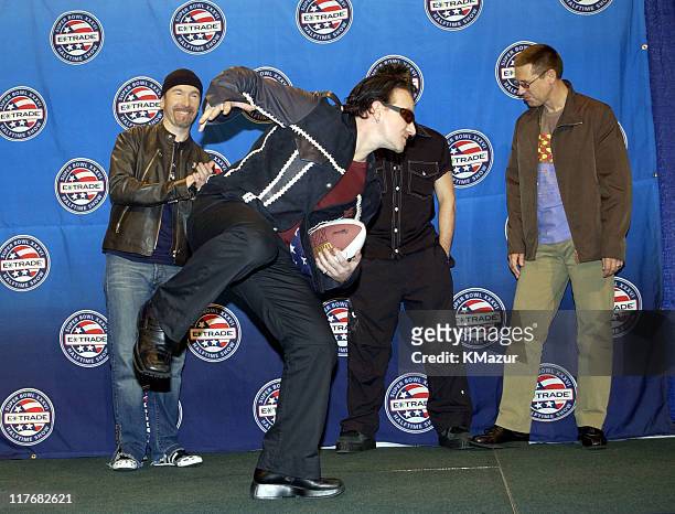 Pose for photographers January 30, 2002 at a press conference at the Superdome in New Orleans, Louisiana, days before their live performance during...