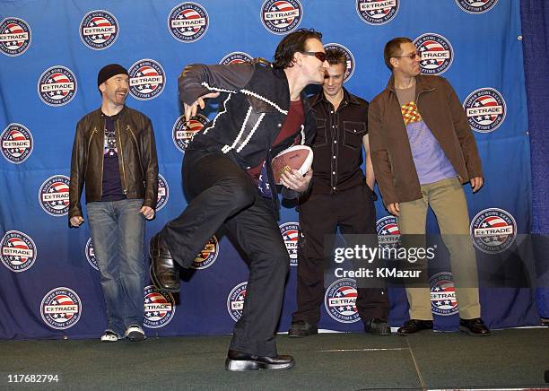 Pose for photographers January 30, 2002 at a press conference at the Superdome in New Orleans, Louisiana, days before their live performance during...