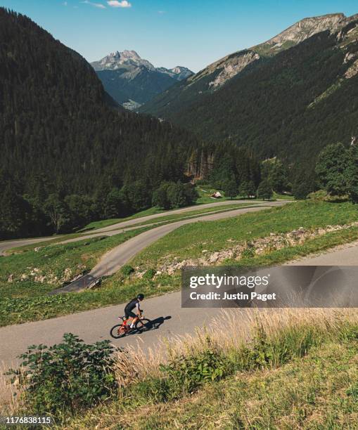 cyclist on col de joux verte - energie verte stockfoto's en -beelden