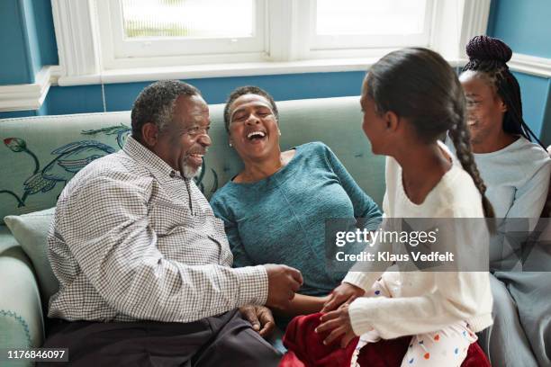 cheerful grandparents enjoying with granddaughters - african american girl wearing a white shirt stock pictures, royalty-free photos & images