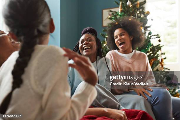 granddaughters enjoying with grandmother at home - african ethnicity christmas stock pictures, royalty-free photos & images