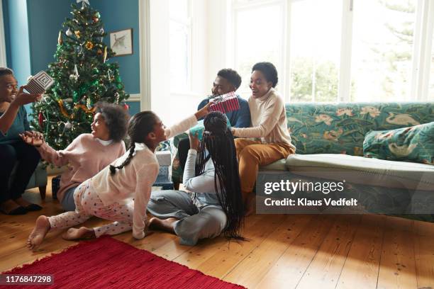 family and friends giving gifts during christmas - child giving gift foto e immagini stock