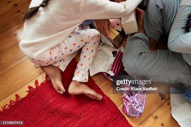 low section of girls with christmas gifts at home - teen girl barefoot at home stock pictures, royalty-free photos & images