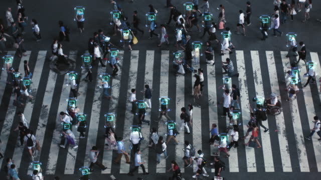 High Angle Shot of a Crowded Pedestrian Crossing in Big City. Augmented Reality Shows Visual Representation of Face Recognition Technology. Artificial Intelligence Learning Process.