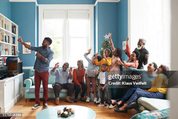 young man taking selfie with family and friends - 12 days of christmas fotografías e imágenes de stock