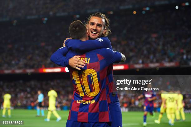 Antoine Griezmann of FC Barcelona celebrates with his teammate Lionel Messi after scoring the opening goal during the Liga match between FC Barcelona...