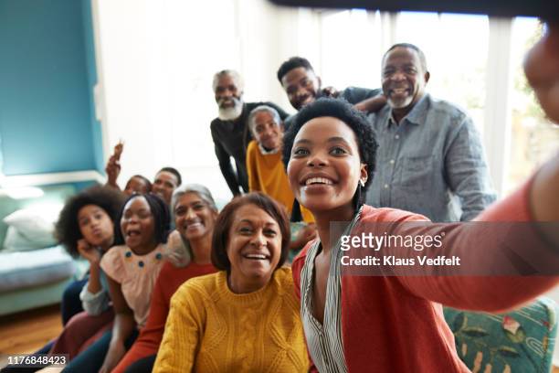 young woman taking selfie with family and friends - sociale bijeenkomst stockfoto's en -beelden