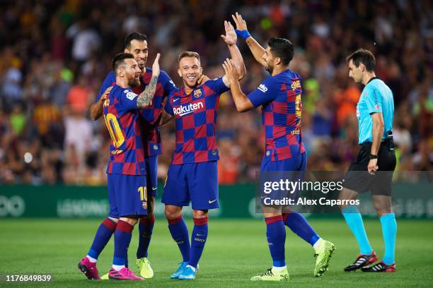Arthur Melo of FC Barcelona celebrates with his teammates Sergio Busquets, Luis Suarez and Lionel Messi after scoring his team's second goal during...
