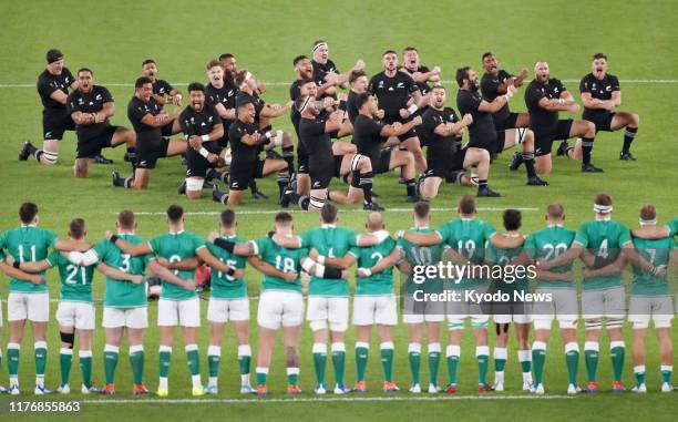 Ireland players watch the New Zealand squad performing the haka prior to a Rugby World Cup quarterfinal match on Oct. 19 in Chofu, western Tokyo.