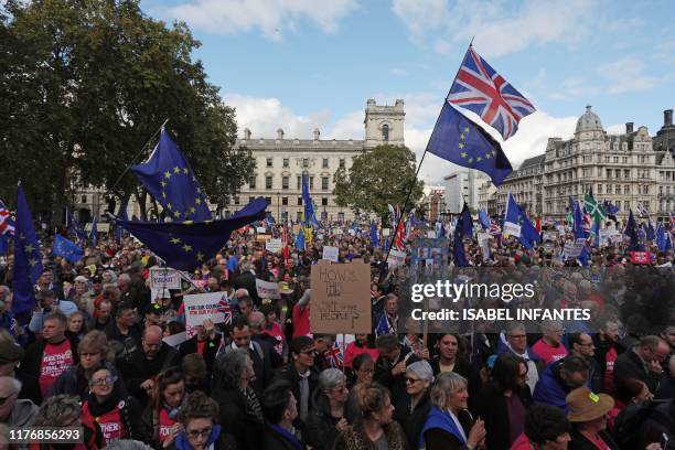 Demonstrators with placards and EU and Union flags gather in Parliament Square in central London on October 19 as they take part in a rally by the...