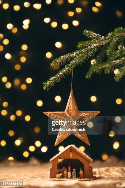 manger under a christmas tree - religion stock pictures, royalty-free photos & images