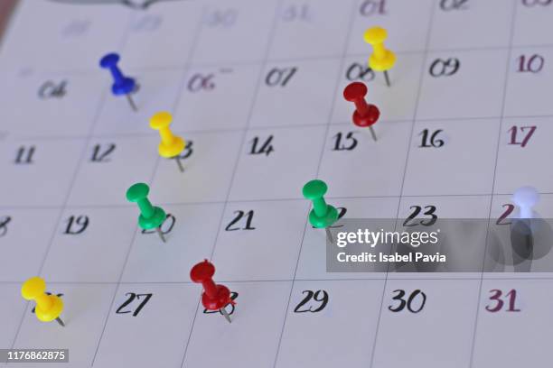 colorful pins on calendar. meeting and stress concept - calendario español fotografías e imágenes de stock