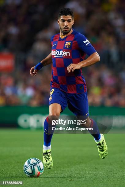 Luis Suarez of FC Barcelona conducts the ball during the Liga match between FC Barcelona and Villarreal CF at Camp Nou on September 24, 2019 in...