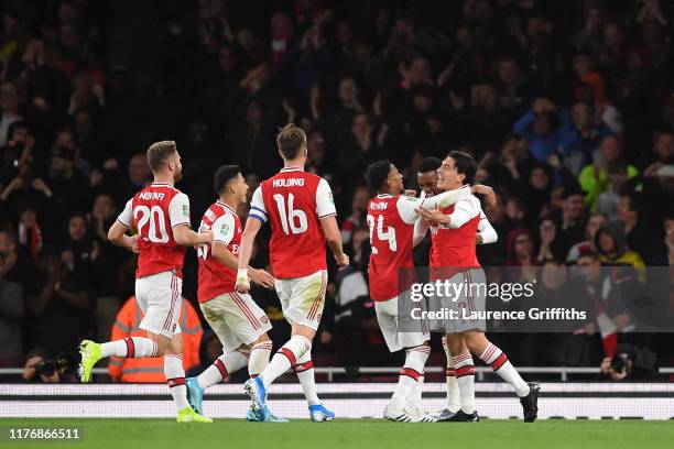 Joe Willock of Arsenal celebrates scoring his teams third goal of the game with team mate Hector Bellerin during the Carabao Cup Third Round match...
