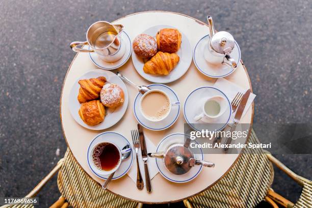 fresh croissants, coffee and tea in french cafe, paris, france - bistro paris fotografías e imágenes de stock