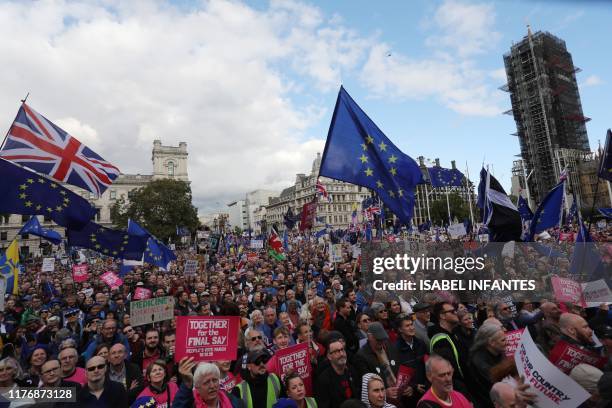 Demonstrators with placards and EU and Union flags gather in Parliament Square in central London on October 19 as they take part in a rally by the...