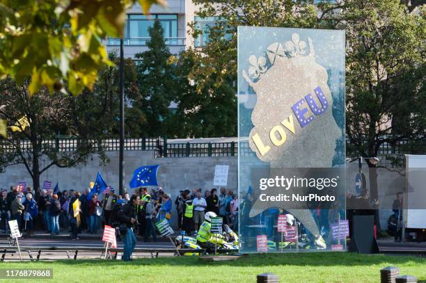 An emblem of Queen Elizabeth II is adorned with pro-EU message as anti-Brexit protesters gather ahead of 'Together for the Final Say' march through...