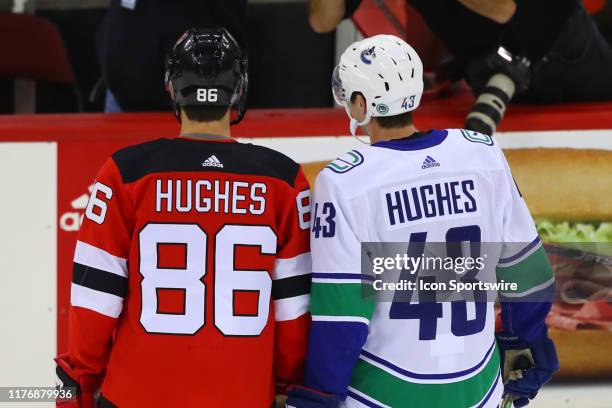 New Jersey Devils center Jack Hughes and his brother Vancouver Canucks defenseman Quinn Hughes prior to the National Hockey League game between the...