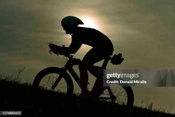 Triathlete climbs up a hill during the IRONMAN 70.3 North Carolina on October 19, 2019 in Wilmington, North Carolina.