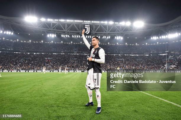 Cristiano Ronaldo of Juventus holds a jersey with the number 700 after being honoured for having scored 700 goals during his career before the Serie...