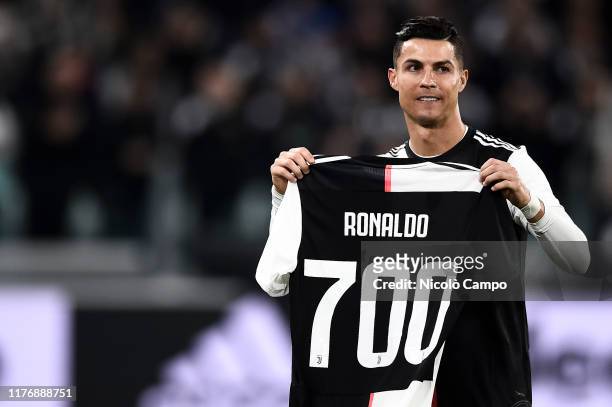 Cristiano Ronaldo of Juventus FC holds a jersey with the number 700 News  Photo - Getty Images