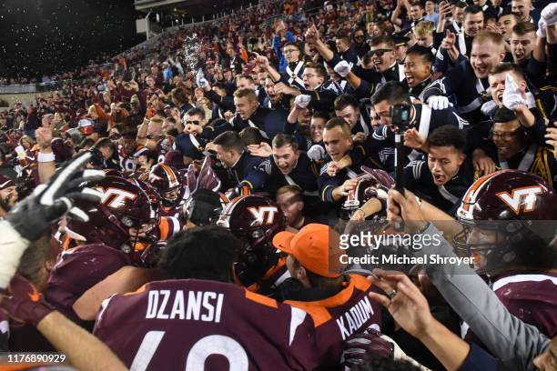 Members of the Virginia Tech Corps of Cadets celebrate with the players following the 6 overtime victory against the North Carolina Tar Heels at Lane...