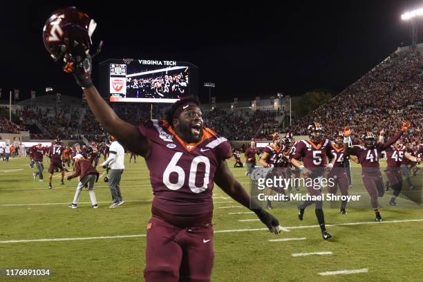 Offensive lineman Silas Dzansi of the Virginia Tech Hokies celebrates following the 6 overtime victory against the North Carolina Tar Heels at Lane...