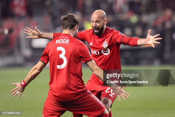 Laurent Ciman of Toronto FC and Drew Moor of Toronto FC celebrate a goal during the MLS Cup Playoffs match between Toronto FC and DC United on...