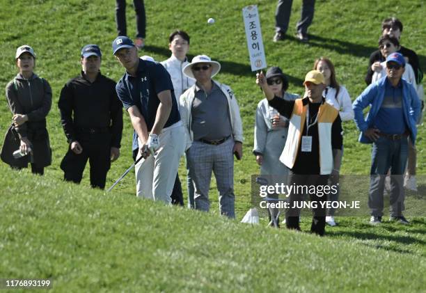 Jordan Spieth of the US chips onto the green on the 3rd hole during the final round of the CJ Cup golf tournament at Nine Bridges golf club in Jeju...