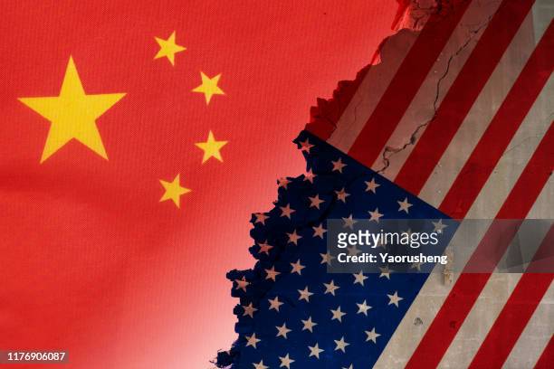 flags of usa and china painted on cracked wall - chinese american stockfoto's en -beelden