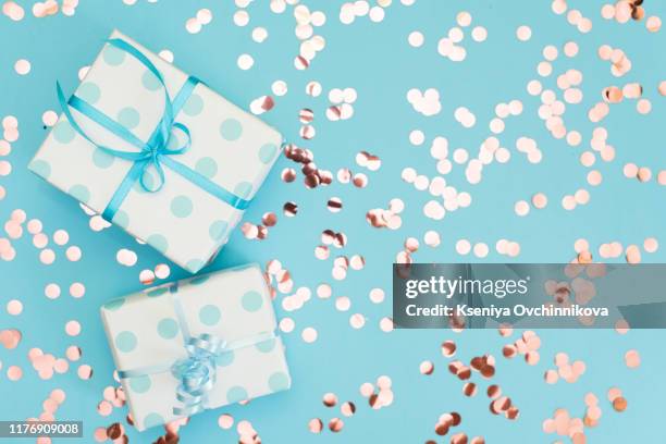 womans hands holding gift or present box decorated confetti on pink pastel table top view. flat lay composition for birthday or wedding. - wedding gift table stock pictures, royalty-free photos & images