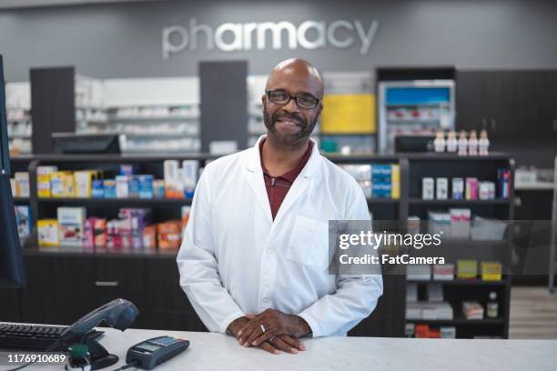 portrait of male pharmacist - black pharmacist stock pictures, royalty-free photos & images