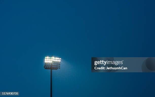 dark blue sky and floodlight in rain - football stadium night stock pictures, royalty-free photos & images