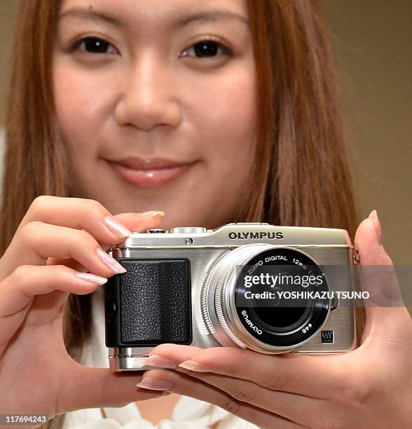 Model displays the new inter changeable lens digital camera of Japanese camera giant Olympus "Pen E-P3", equipped with a 12.3 mega-pixel high-speed...