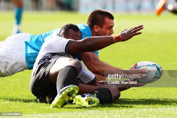 Andres Vilaseca of Uruguay and Vereniki Goneva of Fiji compete for the ball during the Rugby World Cup 2019 Group D game between Fiji and Uruguay at...