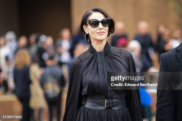 Monica Bellucci wears sunglasses, a black pleated dress, outside Dior, during Paris Fashion Week - Womenswear Spring Summer 2020, on September 24,...