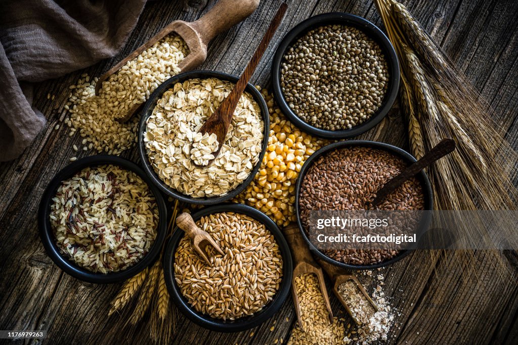 Large group of wholegrain food shot on rustic wooden table