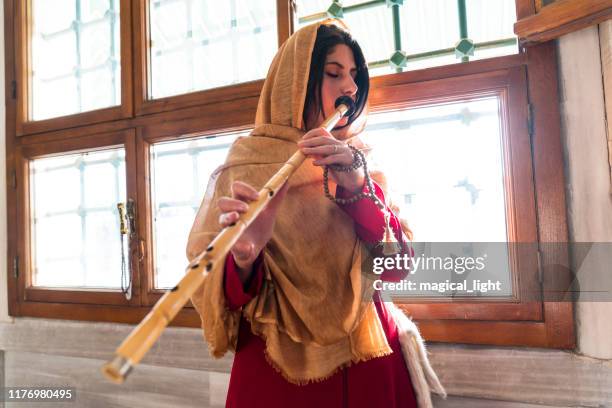 turkish reed flute artist. sufi muslim woman in mosque - sufismo imagens e fotografias de stock
