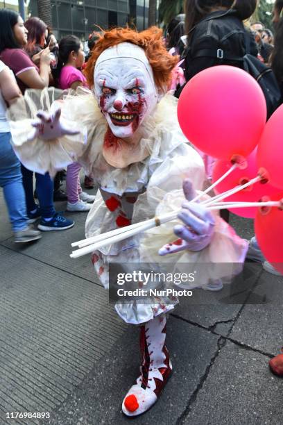 Man disguised as Pennywise is seen taking part during the march of annual Zombie Walk at Monumento of Revolucion on October 19, 2019 in Mexico City,...