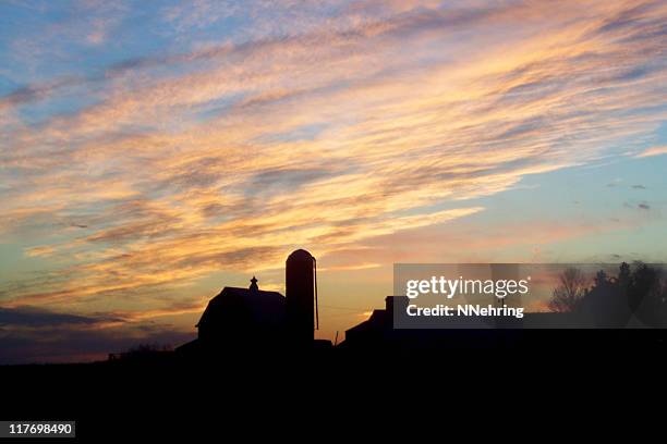 farmland sunset with farm buildings in silhouette - iowa farm stock pictures, royalty-free photos & images