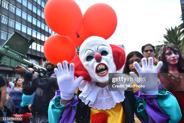 Man disguised as Pennywise is seen taking part during the march of annual Zombie Walk at Monumento of Revolucion on October 19, 2019 in Mexico City,...