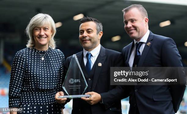 Leeds United owner Andrea Radrizzani and CEO Angus Kinnear accept a trophy from the EFL, celebrating the club's 100th year during the Sky Bet...