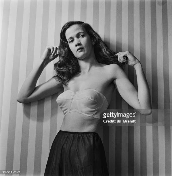 Fashion model demonstrates the latest styles in women's underwear designed by Warner, London, August 1949. Warner developed The ABC Alphabet Bra set...