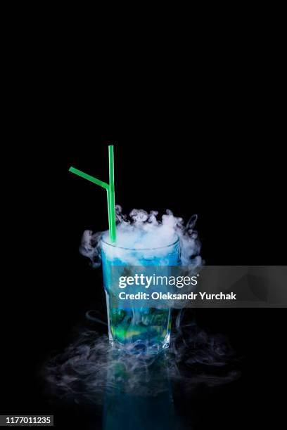 blue alcoholic cocktail with dry ice isolated - dry ice black stock pictures, royalty-free photos & images