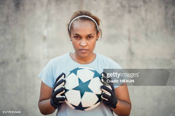 portrait of confident female goalie holding ball - keeper stock pictures, royalty-free photos & images