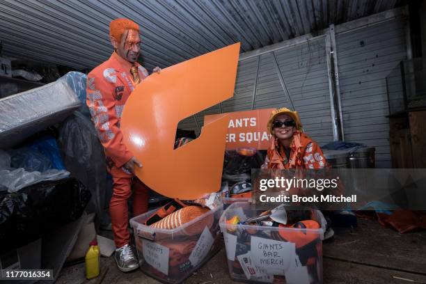 Giants fans Kath and Seb Dell'Orefice dig through mountains of Giants memorabilia in their garage before Saturday's 2019 AFL Grand Final on September...
